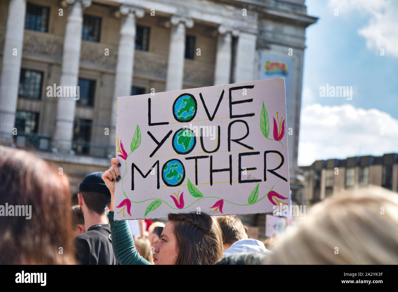 Young female protester holding Love your mother placard, 20th September global climate strike, Old Market Square, Nottingham, East Midlands, England Stock Photo