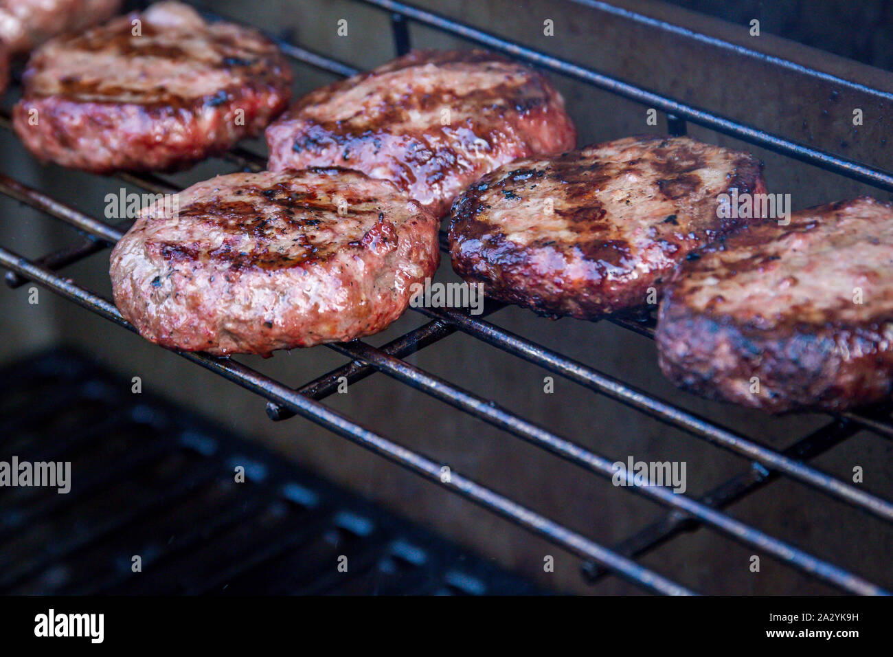 Juicy barbecued beef burgers on a barbecue warming rack Stock Photo - Alamy
