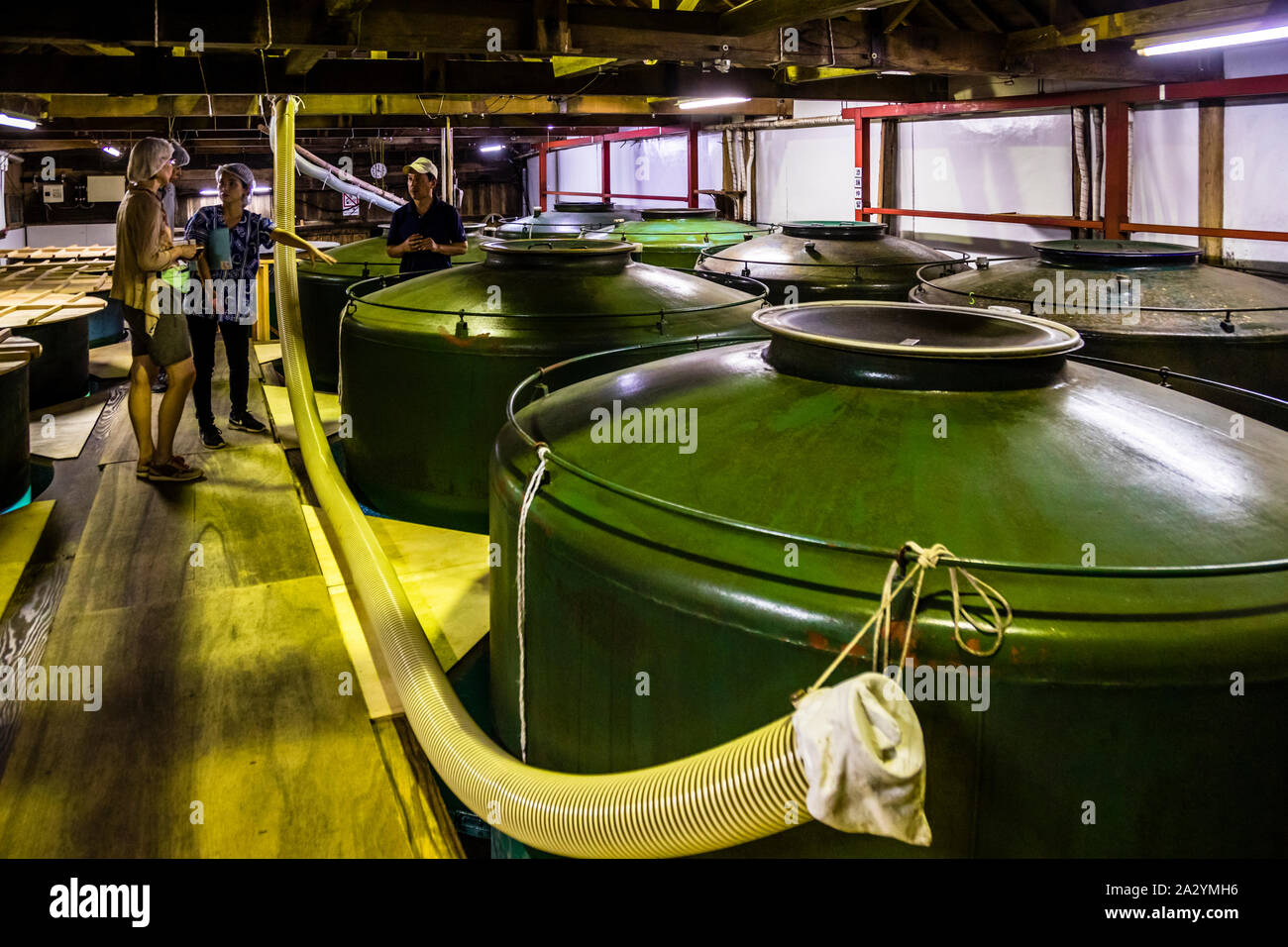 Sake Factury in Fujinomiya, Shzuoka, Japan. The green tanks for sake production used to be warships of the Japanese Navy Stock Photo