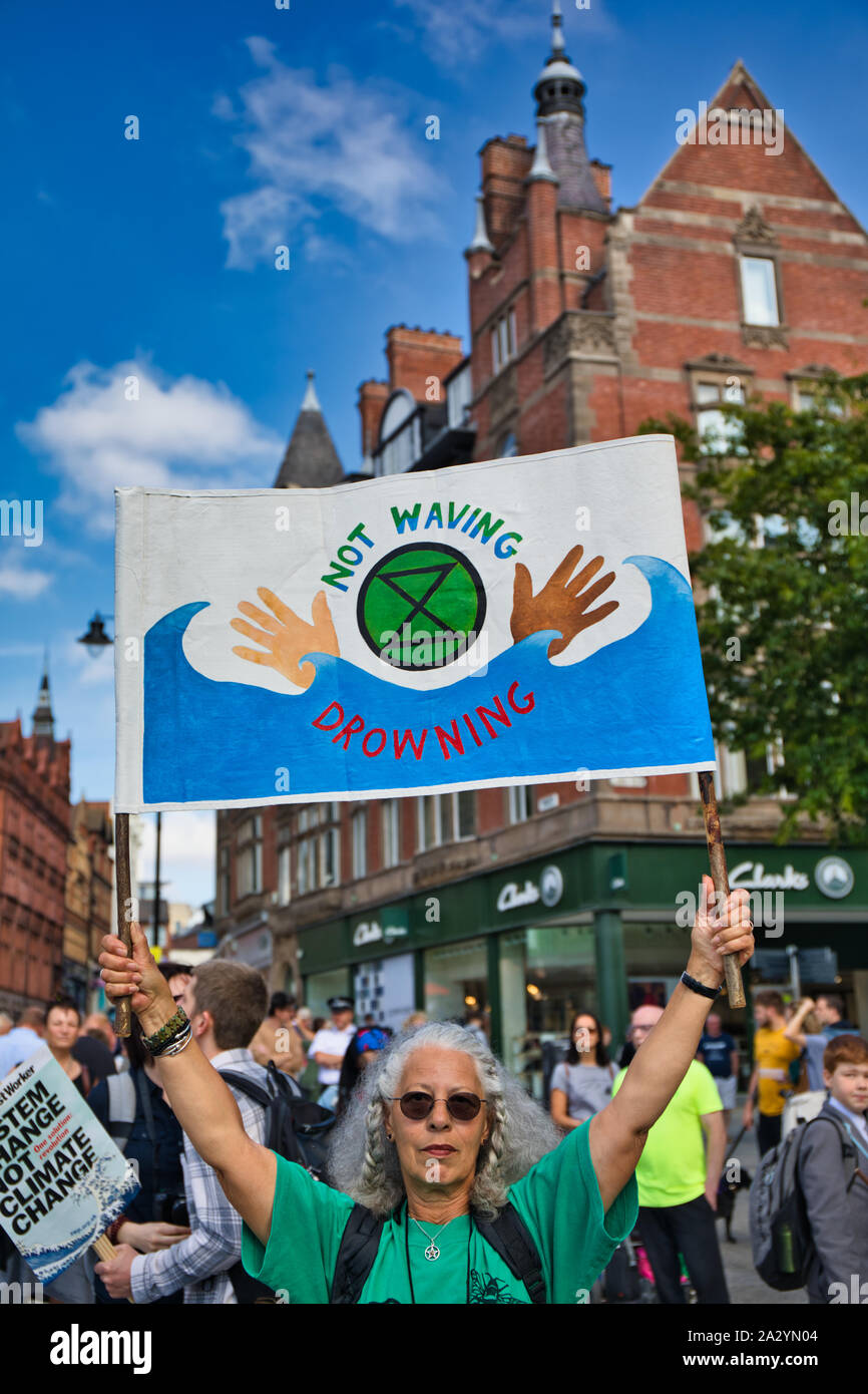 Woman holding up climate change banner at the 20th September global climate strike, Old Market Square, Nottingham, East Midlands, England Stock Photo
