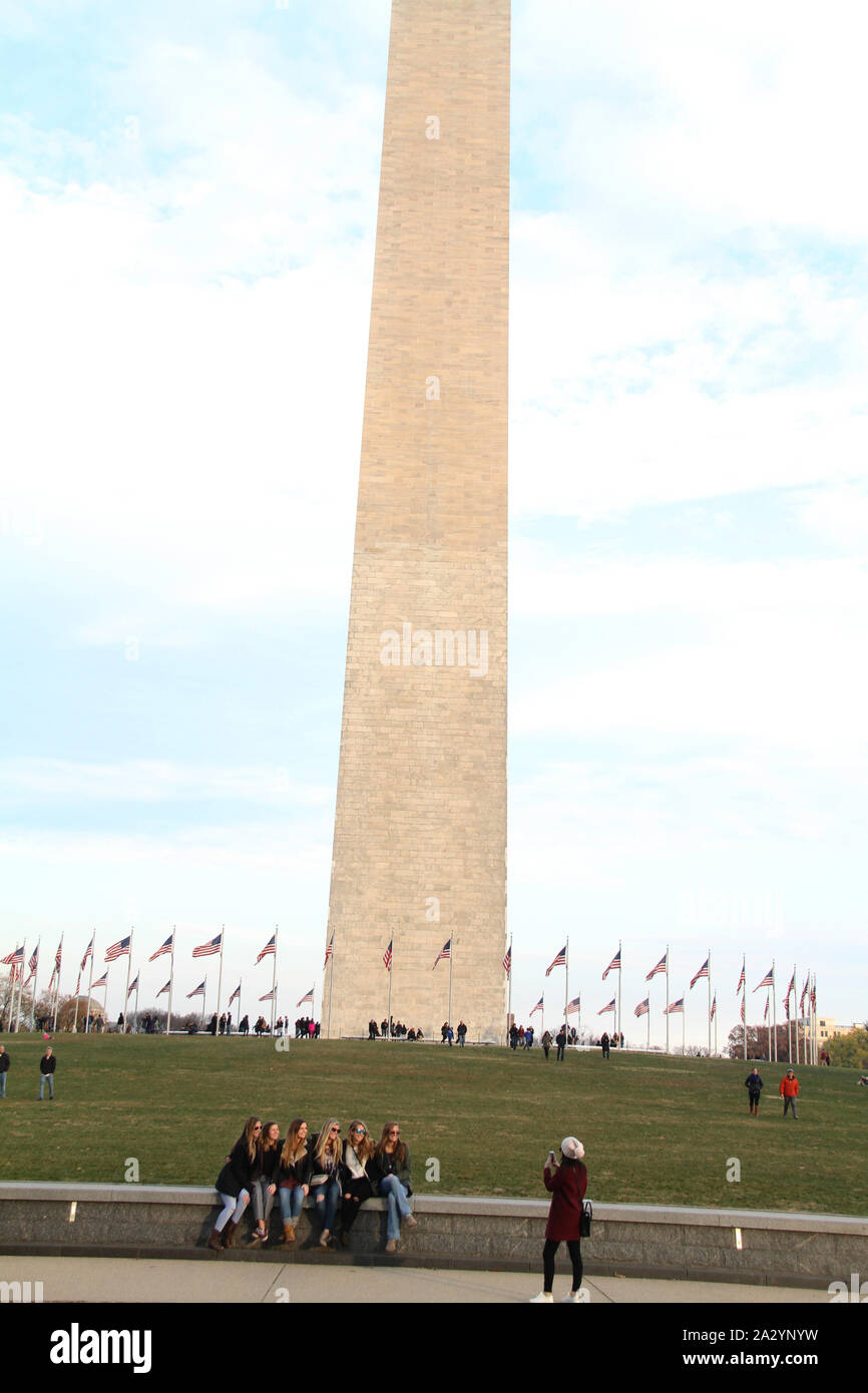 Group of young women taking pictures in front of the Washington Monument in Washington DC, USA Stock Photo
