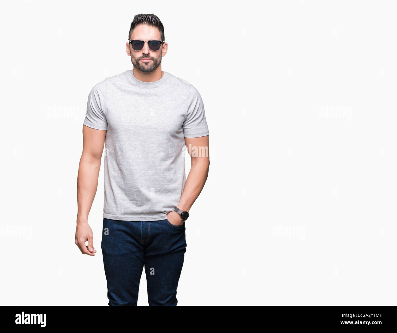 Young handsome man wearing sunglasses over isolated background with a ...