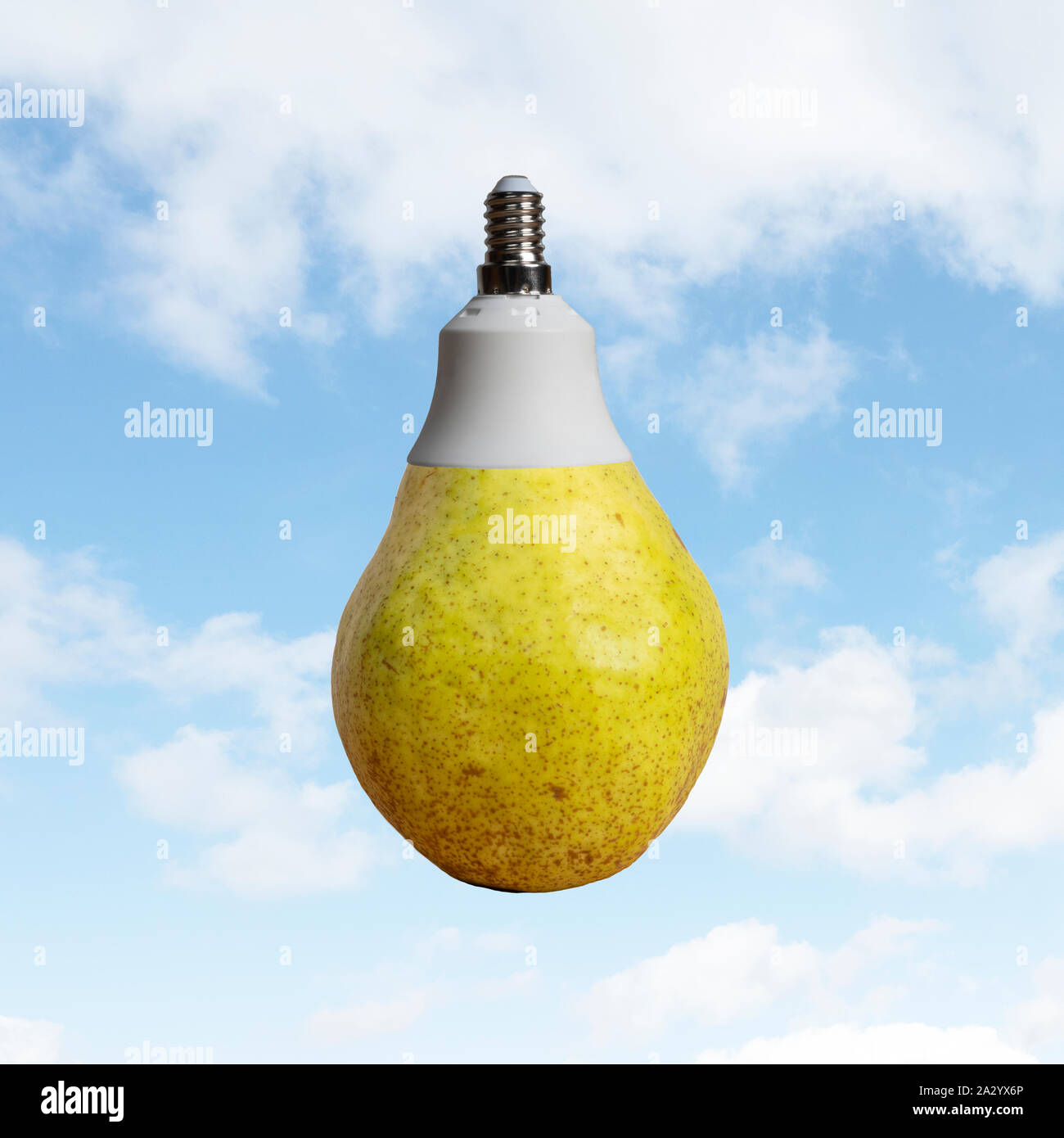 A pear with a light bulb attack with a sky in the background Stock Photo