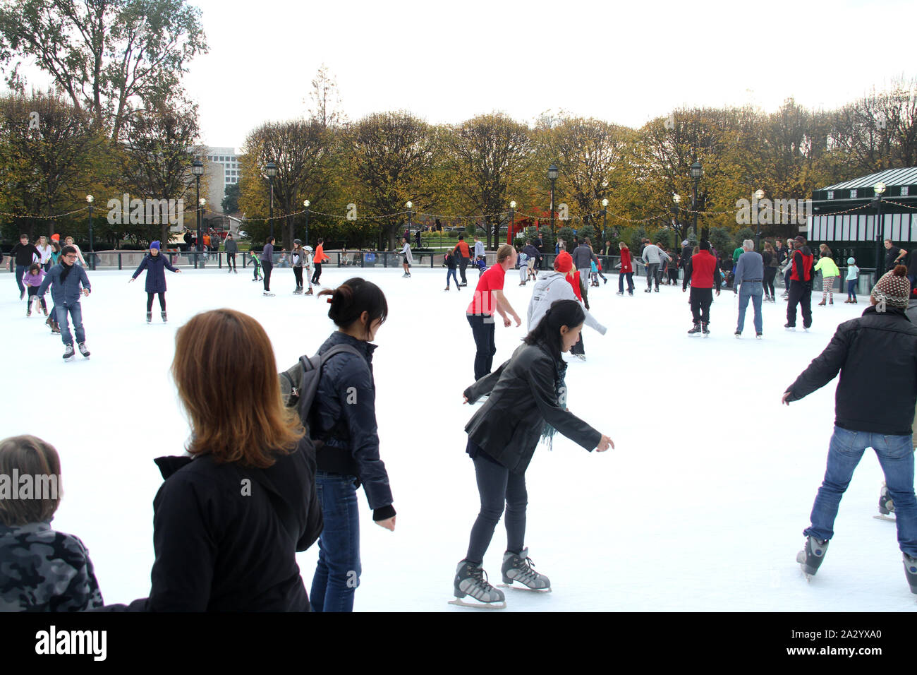 People iceskating on the rink at the National Gallery of Art Sculpture