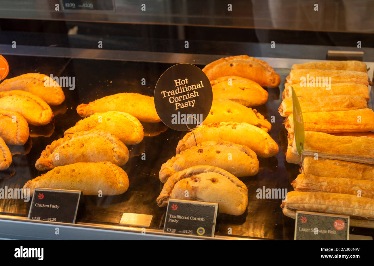 Hot traditional Cornish pasty in display inside bakery shop, UK