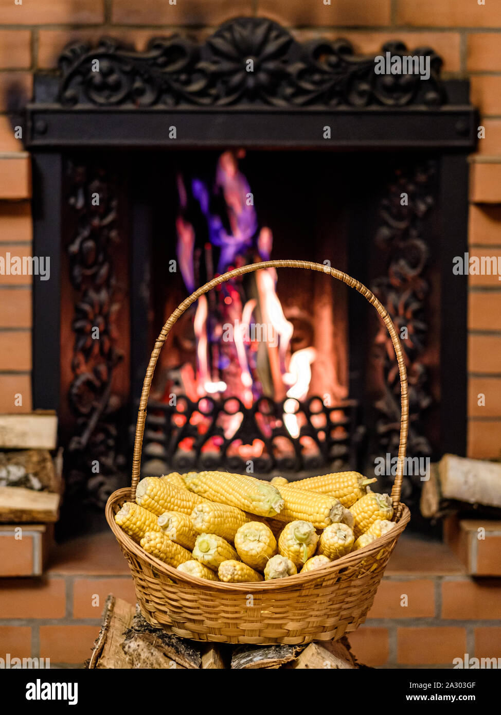 A wicker basket to the top filled with ears of ripe corn. In the