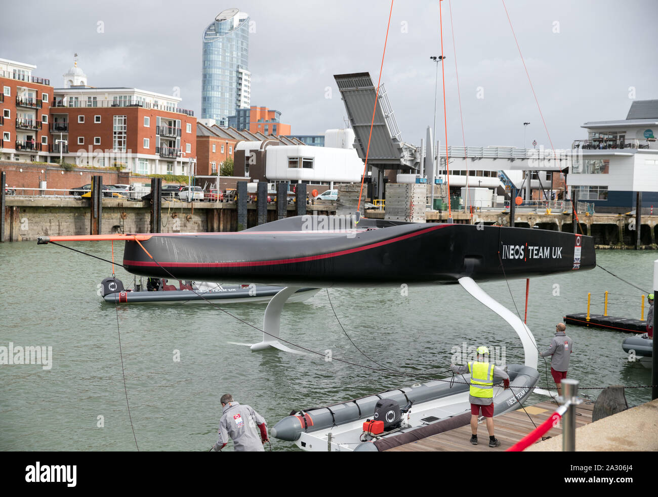 The Ineos Team UK America's Cup boat 'Britannia' is lowered into the water during its launch event in Portsmouth. Stock Photo