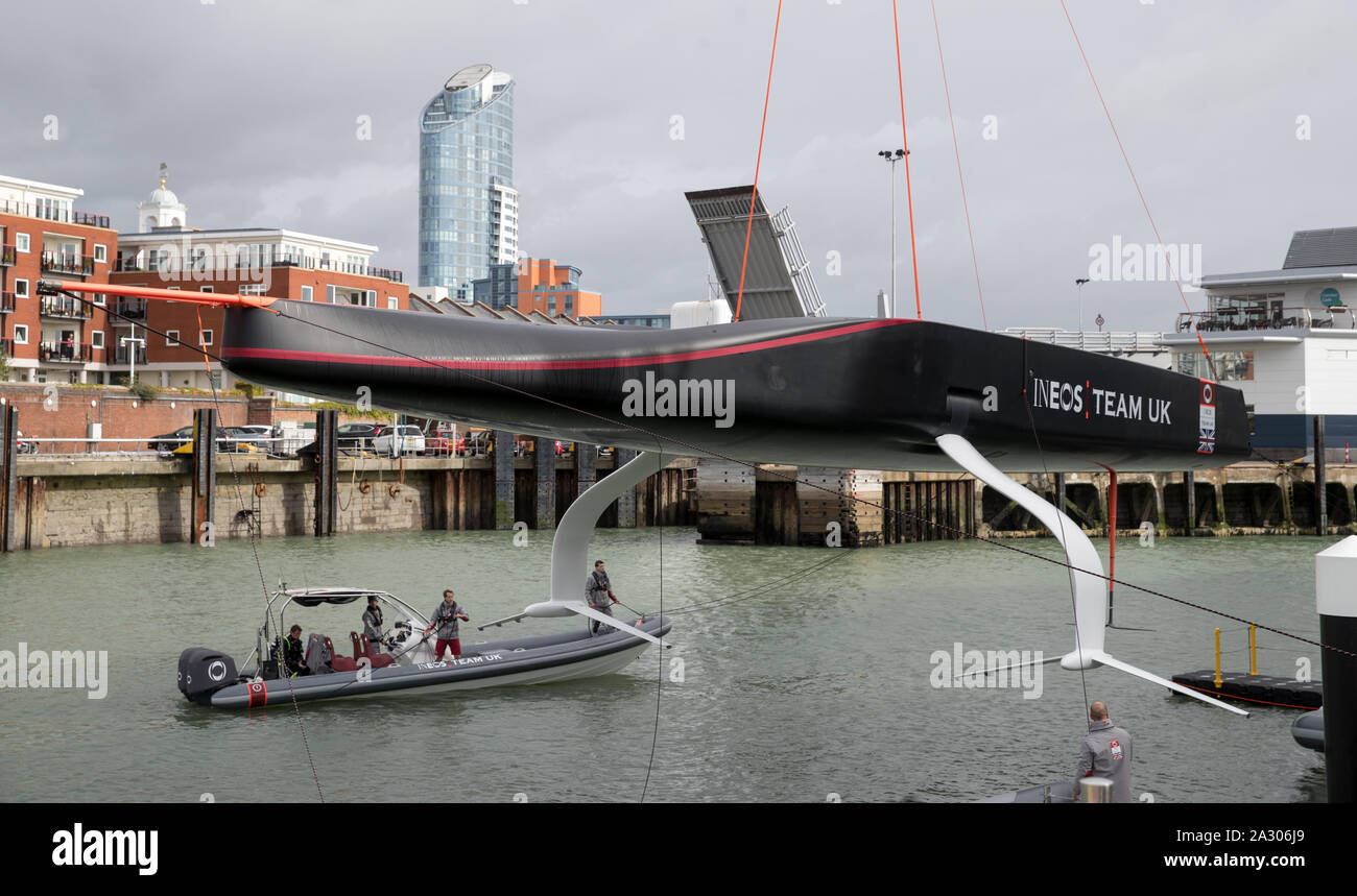 The Ineos Team UK America's Cup boat 'Britannia' is lowered into the water during its launch event in Portsmouth. Stock Photo