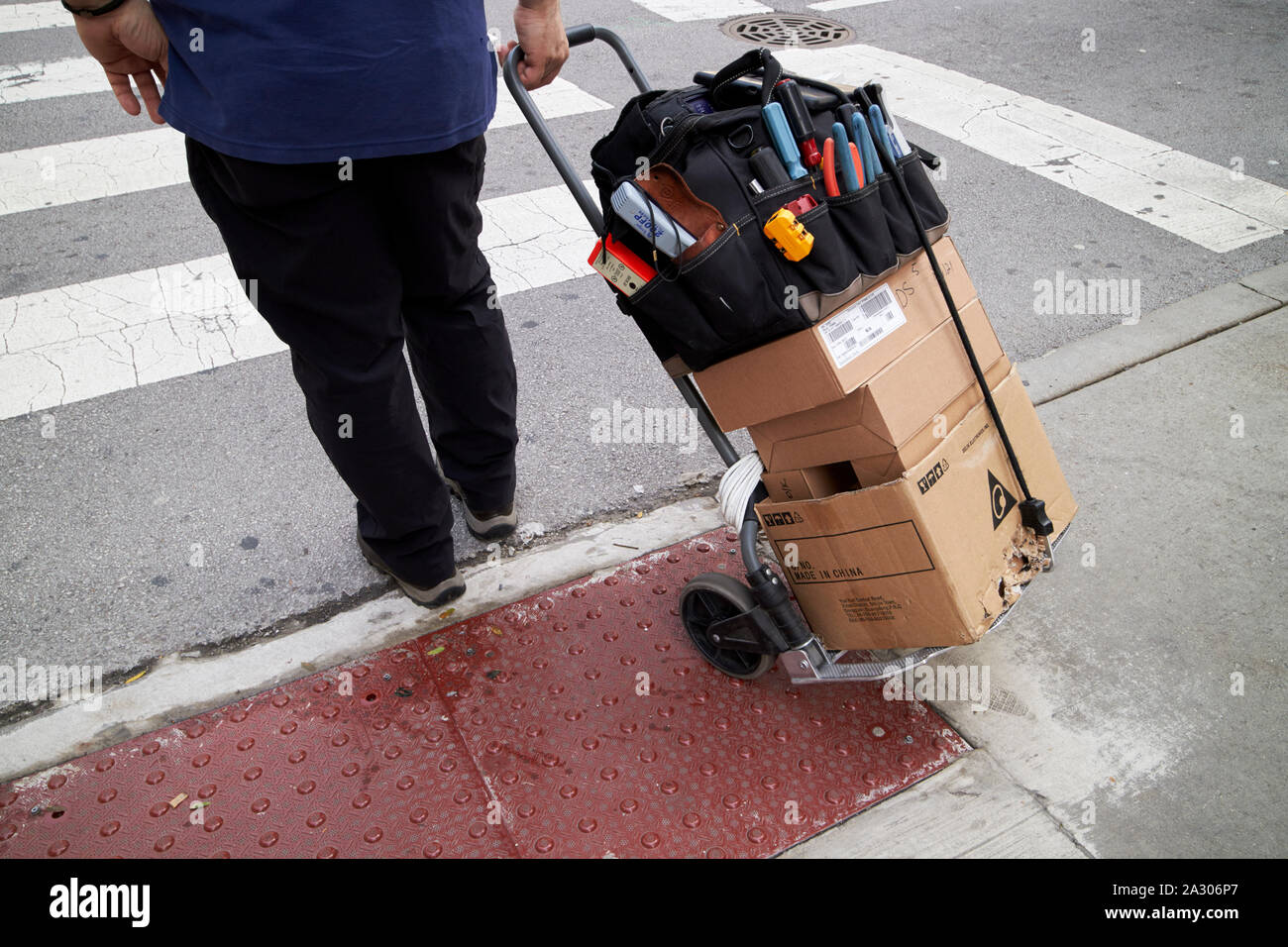 electrician with tools and communications cables on wheeled trolley in downtown chicago illinois united states of america Stock Photo