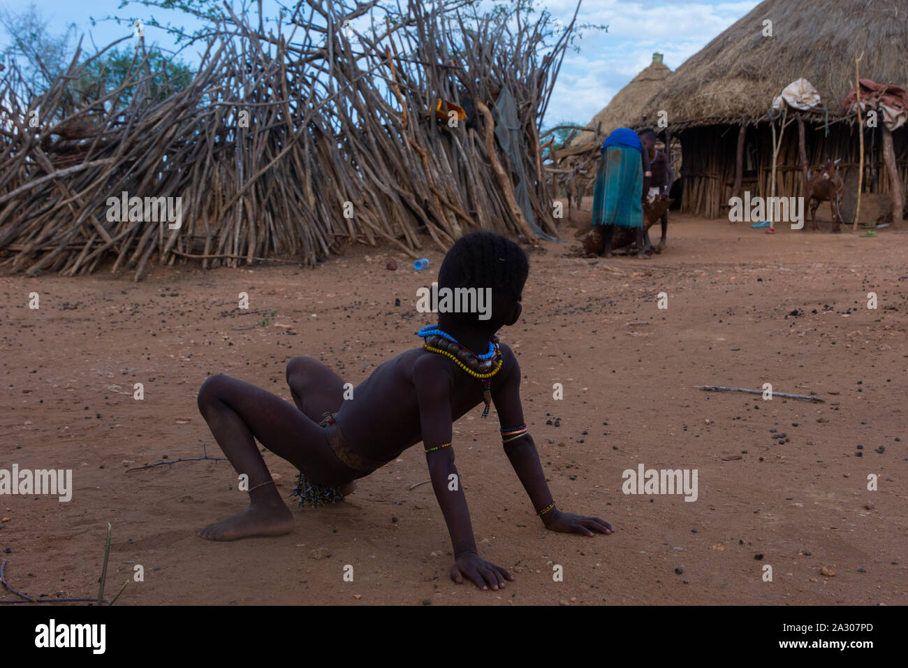 Turmi, Ethiopia - Nov 2018: Young Hamer tribe kid playing next to the house, Omo valley Stock Photo