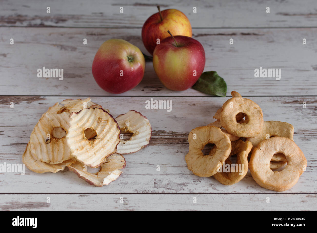 Dried apple rings and apple crisp chips in comparison with fresh red