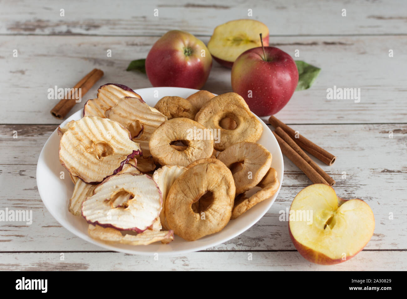 Dried apple rings and apple crisp chips in comparison with fresh red