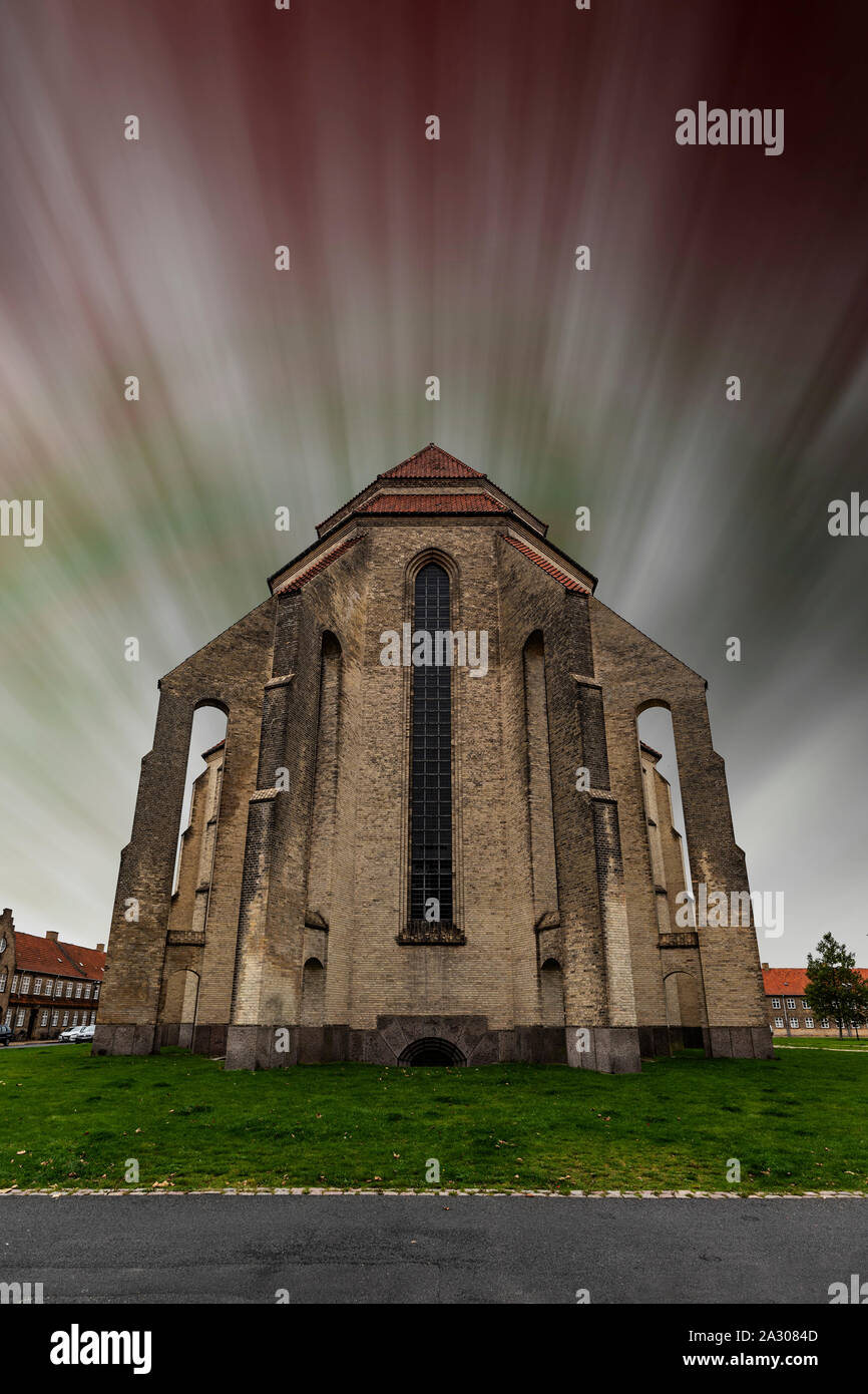 Grundtvig's Church is located in the Bispebjerg district of Copenhagen, Denmark. A fake sunburst like aurora effect has been added. Stock Photo
