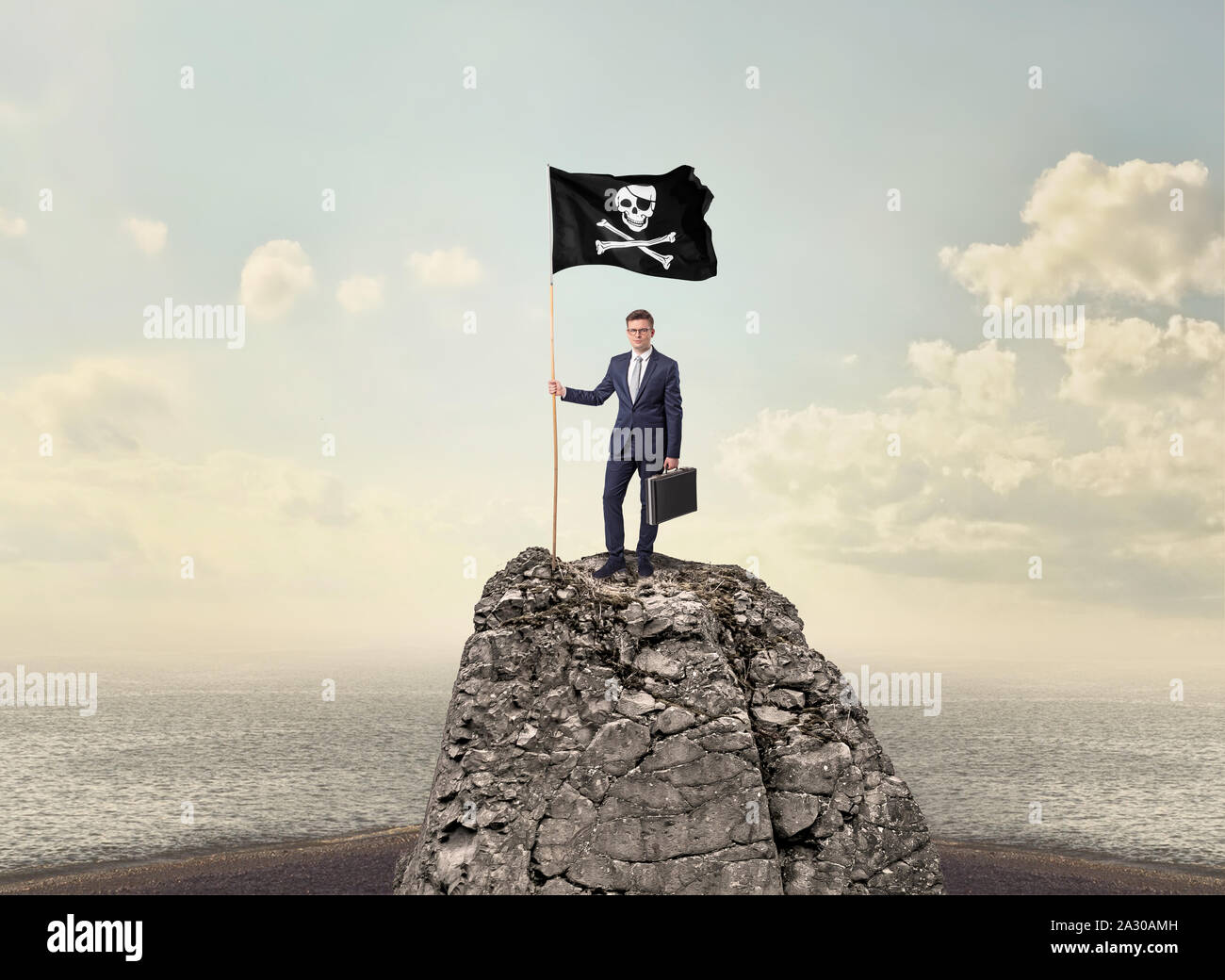Successful businessman on the top of a mountain holding pirate flag ...