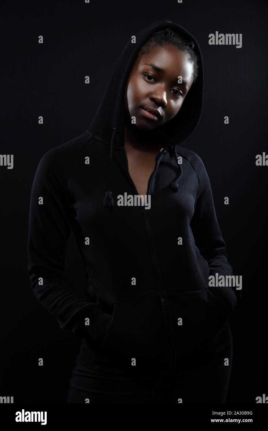 Cool and chill woman with dark skin and attitude wearing hoodie Stock Photo