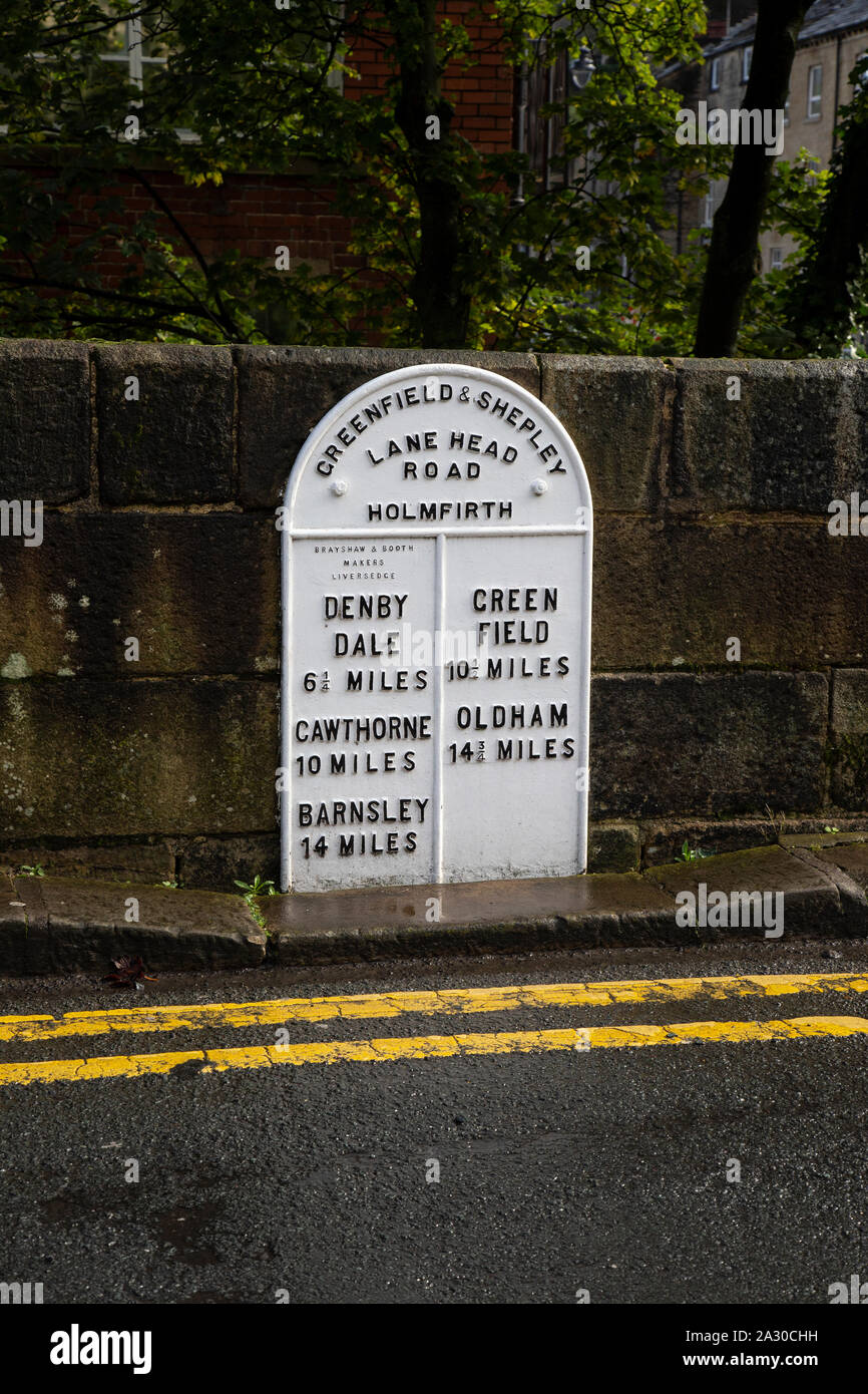 Milestone marker on Lane Head Road Holmfirth, West Yorkshire showing distances to local towns a relic of horse travel Stock Photo