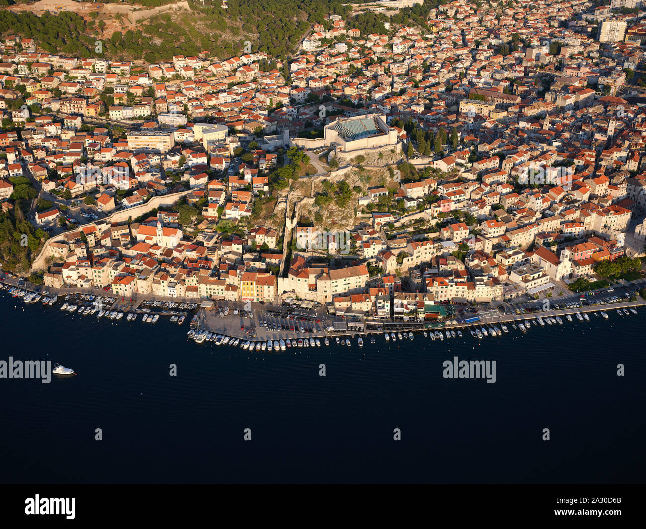 AERIAL VIEW. Medieval hilltop town of Šibenik crowned with St. Michael's Fortress. Dalmatia, Croatia. Stock Photo