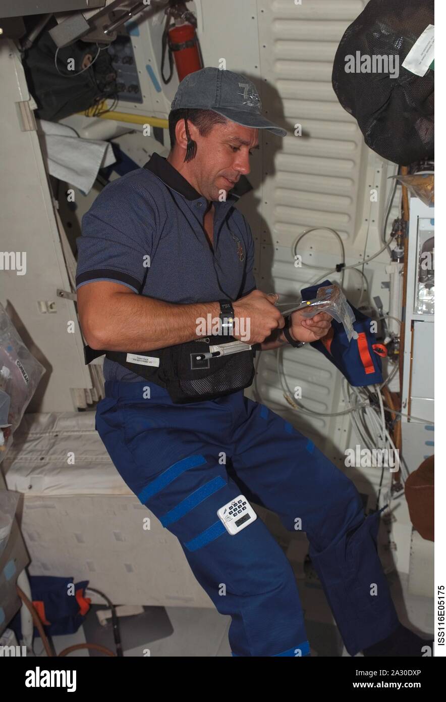 In Earth Orbit, USA. 5th Feb, 2007. FILE: In this photo released by NASA, Astronaut William A. (Bill) Oefelein, STS-116 pilot, opens a package of food on the middeck of Space Shuttle Discovery in Earth orbit on December 10, 2006 Credit: Nasa/CNP/ZUMA Wire/Alamy Live News Stock Photo