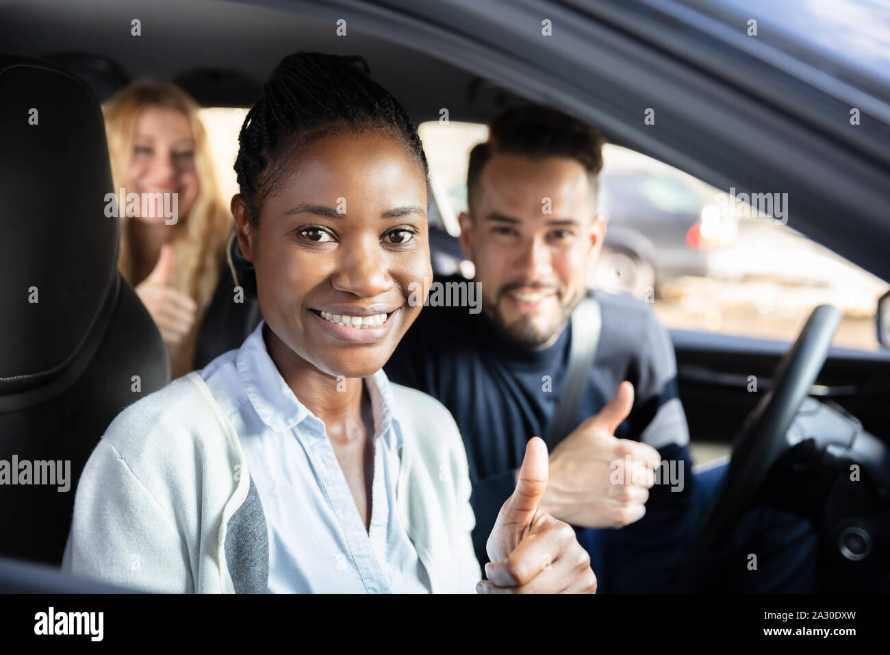 Thumbs up african woman sitting hi-res stock photography and images - Alamy