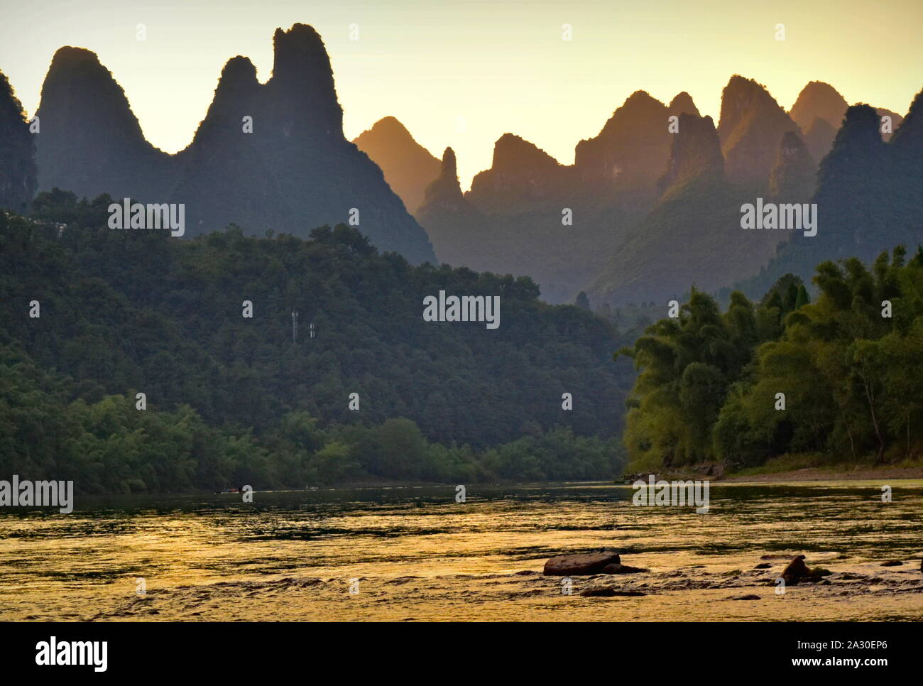 Sunset behind beautiful Li river basin mountain peaks - Guangxi, China Stock Photo
