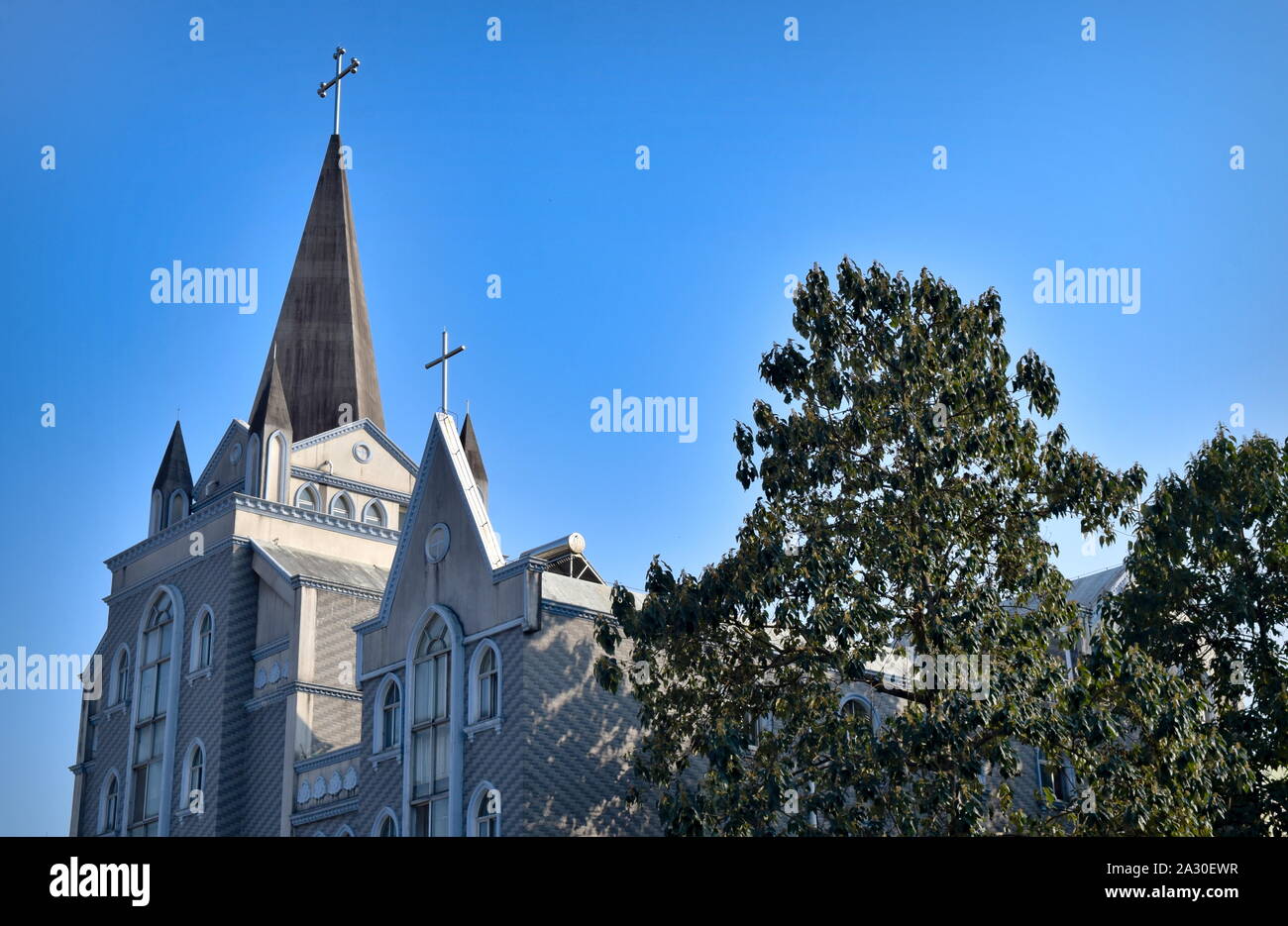 Christianity in China: Guilin large Catholic church tower and crosses Stock Photo