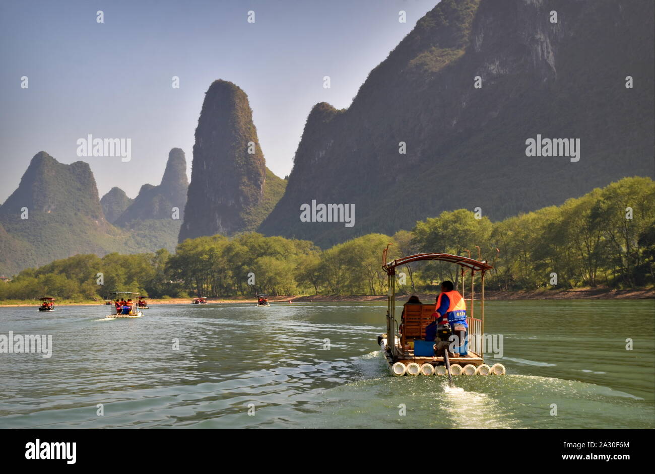 Li river bamboo raft boats and beautiful green mountain peaks - Guilin, China Stock Photo