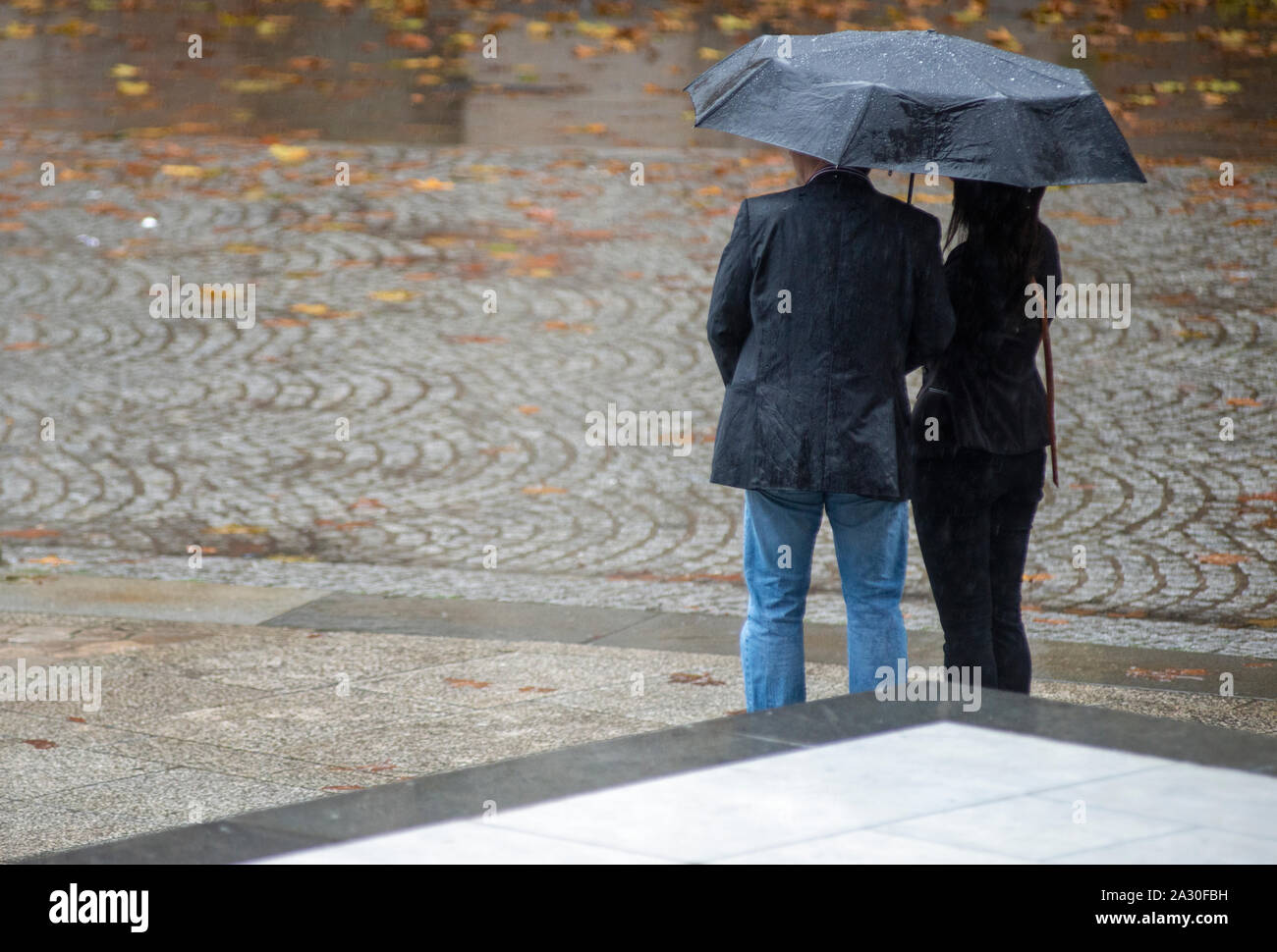 Man and woman under umbrella hi-res stock photography and images - Alamy