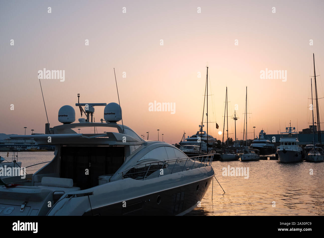 AUG 2019 Port of Cagliari at sunset with yacht and boats - Sardinia Italy Stock Photo