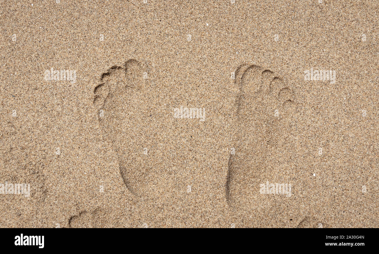 On the coast. Photo footprints in the sand Stock Photo