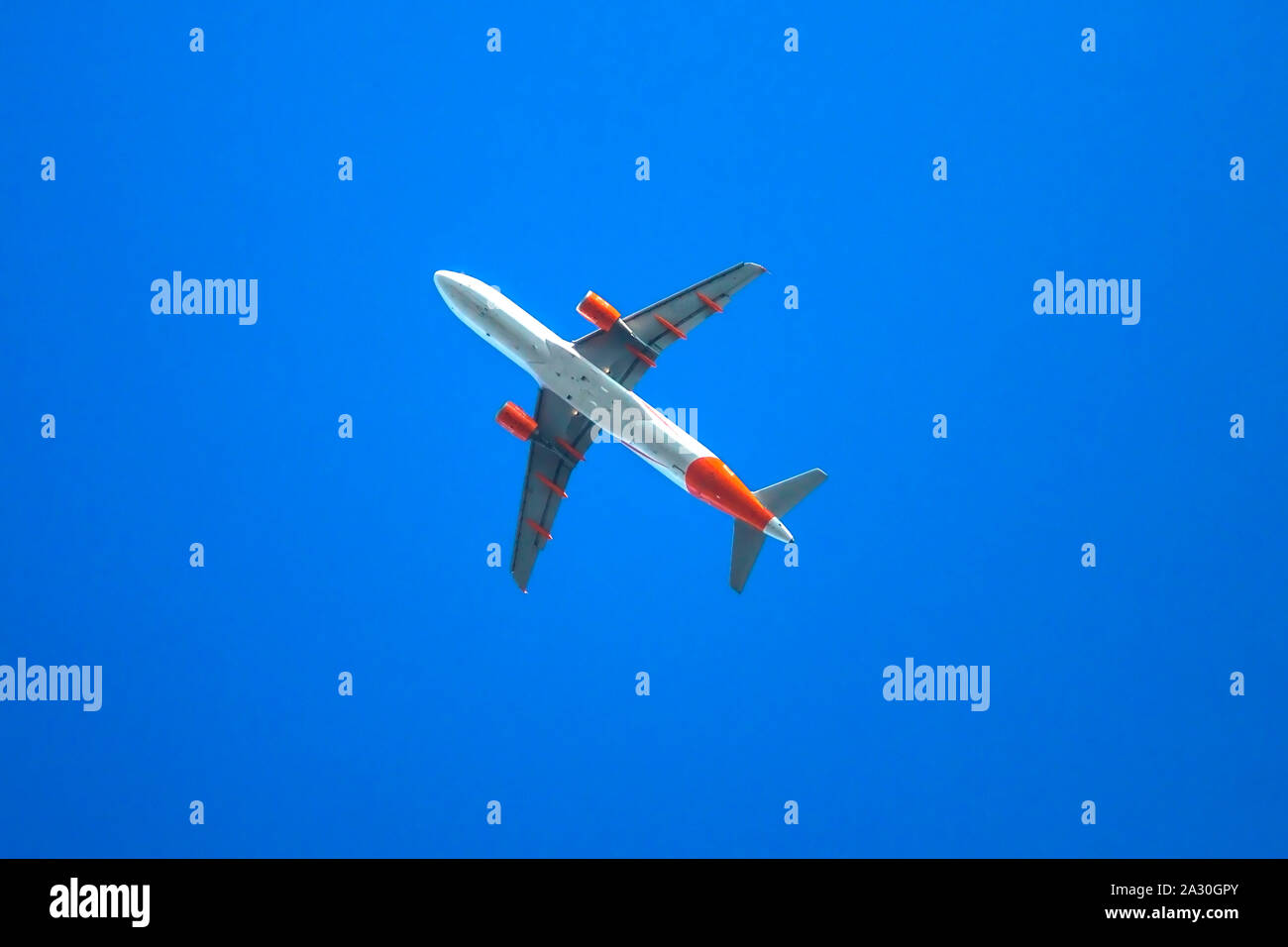 Plane on blue sky background Stock Photo - Alamy