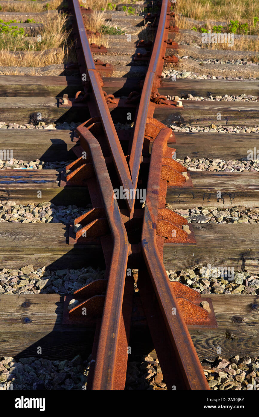 Abandoned and rusty rail track showing switch and crossing Stock Photo