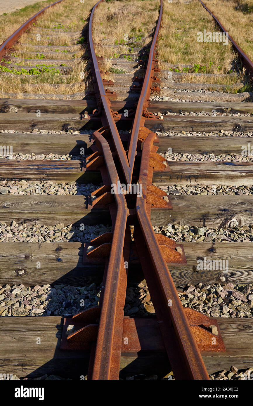 Rusting redundant railway track showing switch and crossing Stock Photo