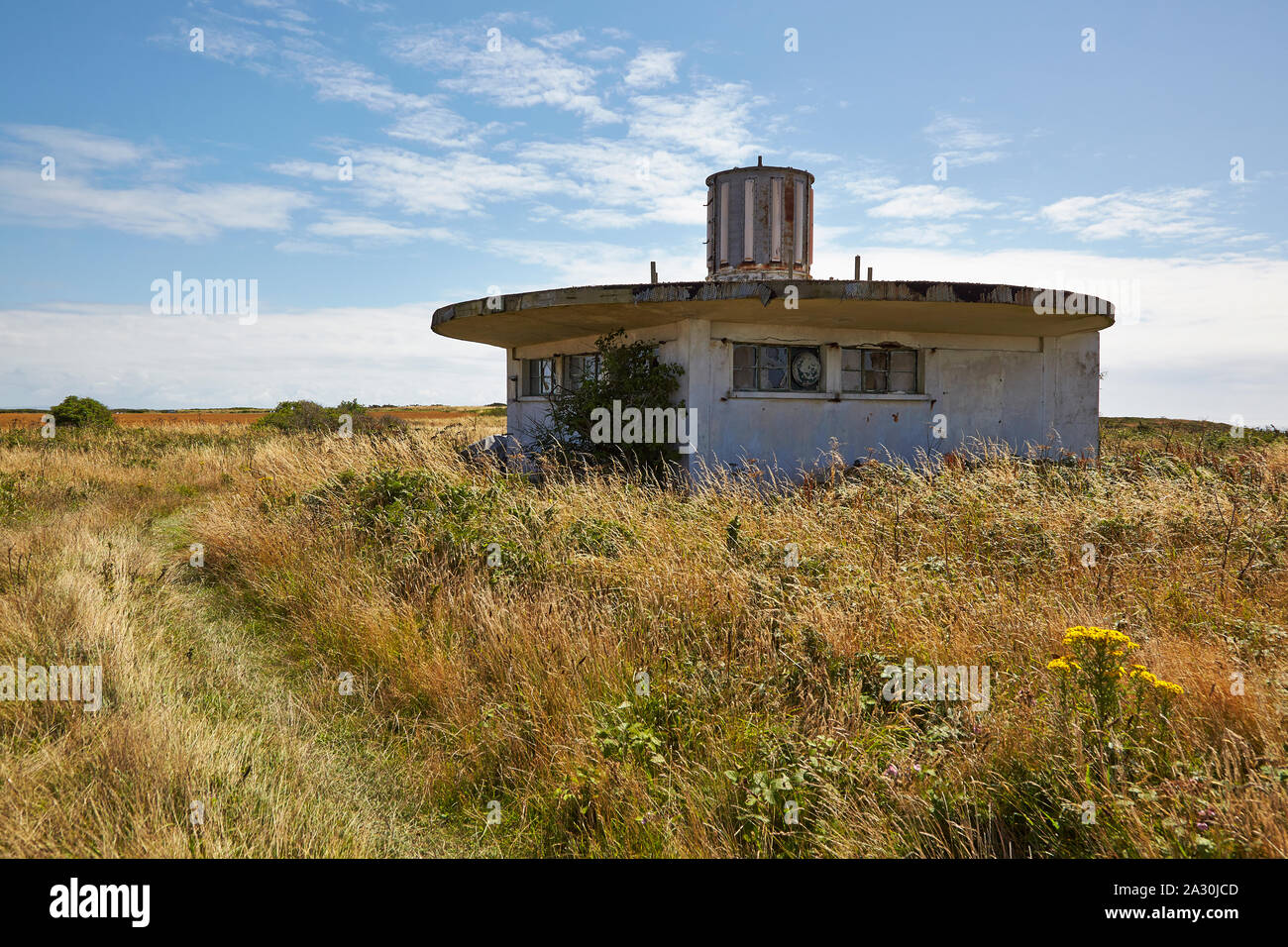 Disused concrete navigation building located in the former WW II German Concentration camp SS Lager Sylt on the island of Alderney, Channel Islands Stock Photo