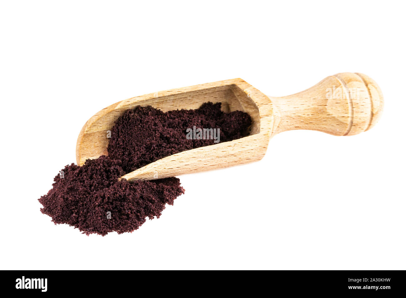 Acai powder. Acai palm fruit berry powder in wooden scop isolated on white Stock Photo