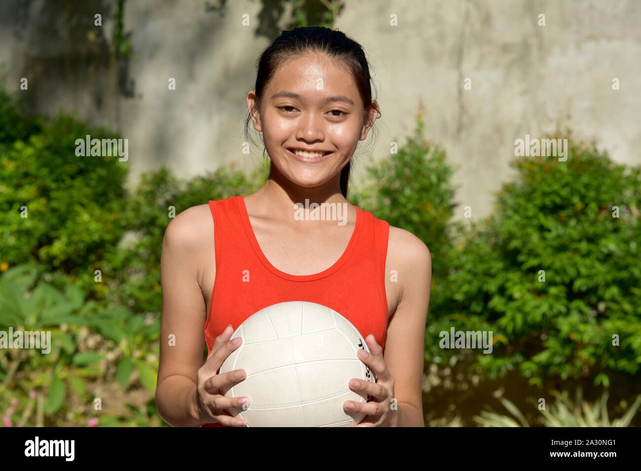 Happy Athletic Asian Person With Volleyball Stock Photo