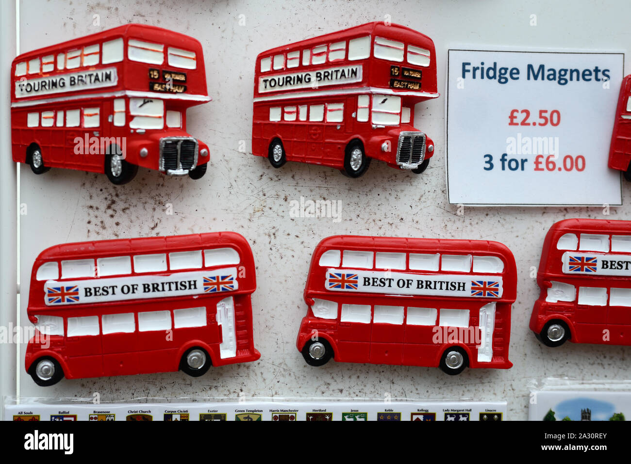 Iconic Red Double-Decker London Buses. Souvenir Badges or Fridge Magnets For Sale on Souvenir Stall London England UK Stock Photo