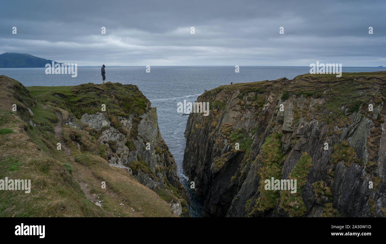 Person standing on cliff, Achill Island, County Mayo, Ireland Stock Photo