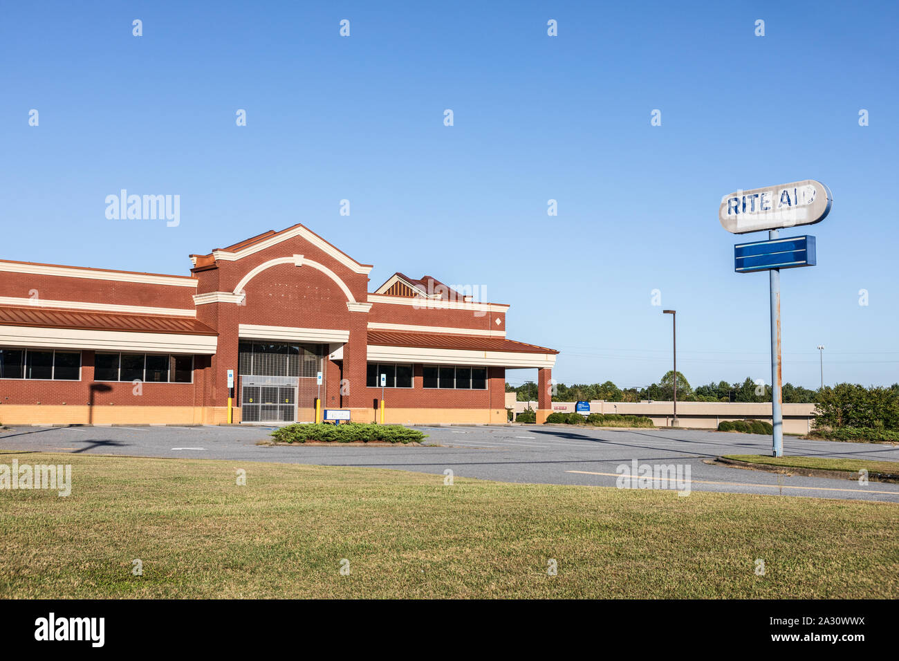 HUDSON, NC, USA-24 SEPT 2019: A closed Rite Aid pharmacy, building and road sign. Stock Photo
