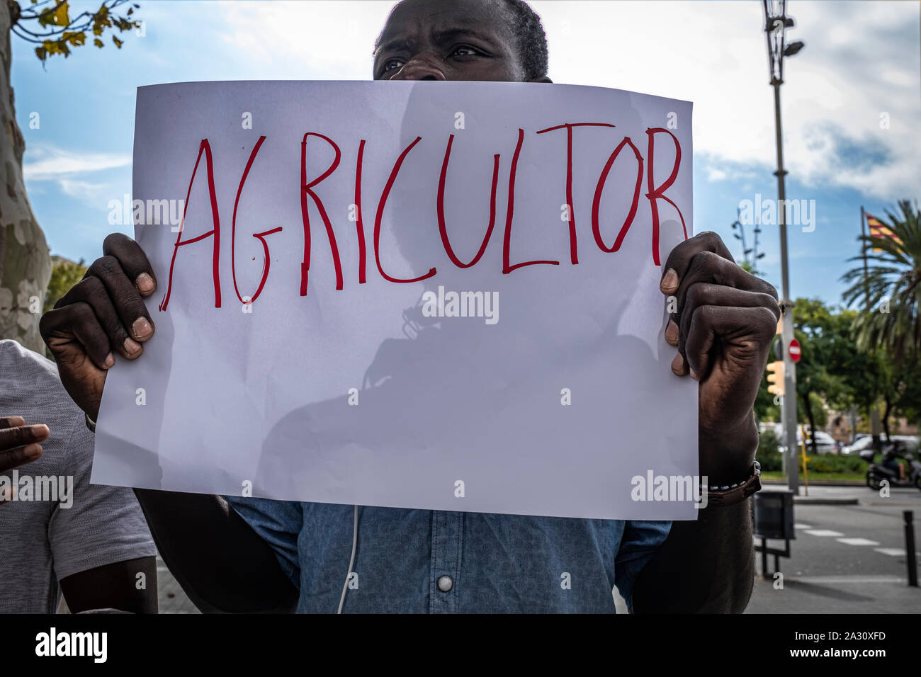 Barcelona, Spain. 04th Oct, 2019. A street vendor holds a placard during the press conference.Street vendors, known as 'manteros' for selling their merchandise in the street on a blanket, have called a press conference to denounce that they have been under police pressure for several months that prevents them from selling and making a living. Credit: SOPA Images Limited/Alamy Live News Stock Photo