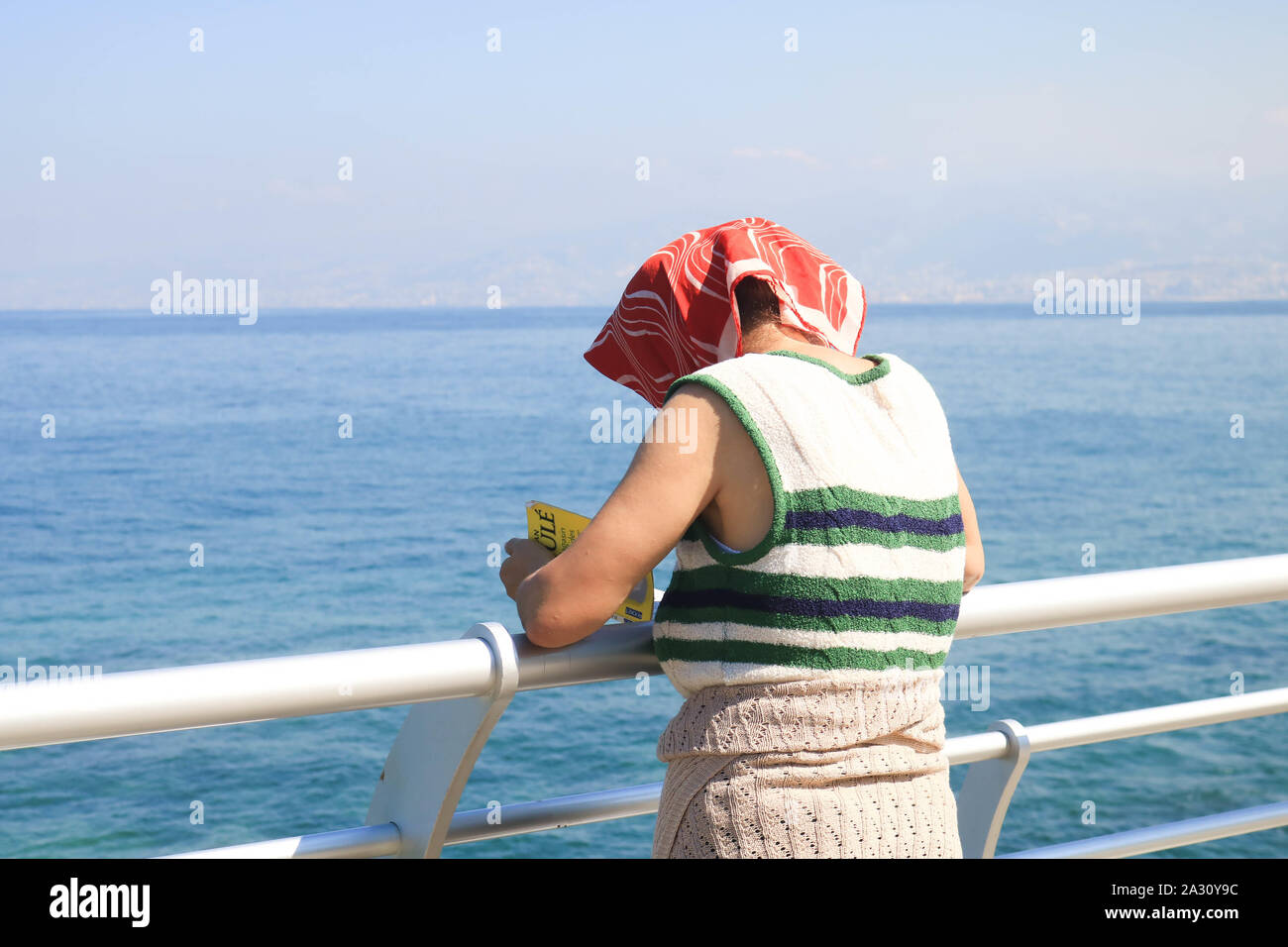 October 4, 2019, Beirut, Lebanon: A woman covering her head on Beirut promenade seafront from the hot weather, (Credit Image: © Amer Ghazzal/SOPA Images via ZUMA Wire) Stock Photo