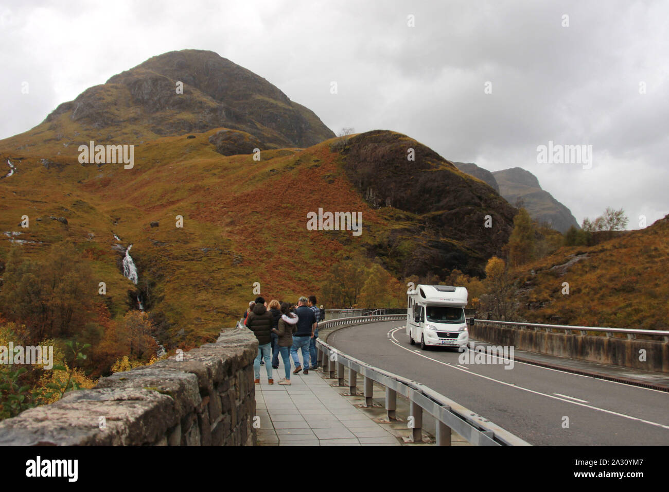 Tourists looking at beautiful mountain view in Scottish Highlands. Glencoe, Scotland, UK Stock Photo