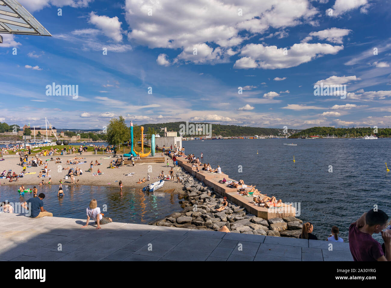 OSLO, NORWAY - People sunbathing and swimming at Filipstad, Oslo waterfront. Stock Photo