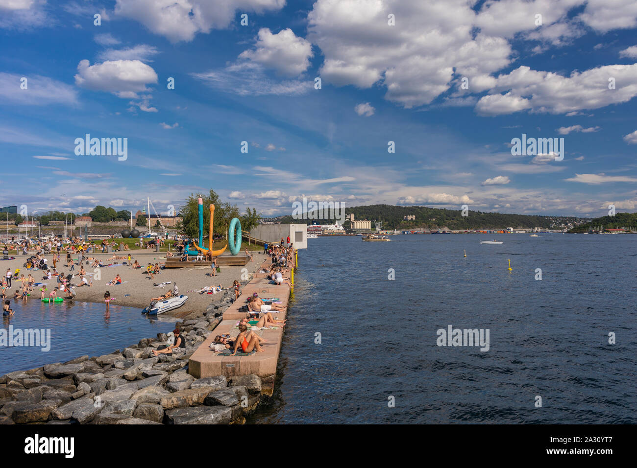 OSLO, NORWAY - People sunbathing and swimming at Filipstad, Oslo waterfront. Stock Photo