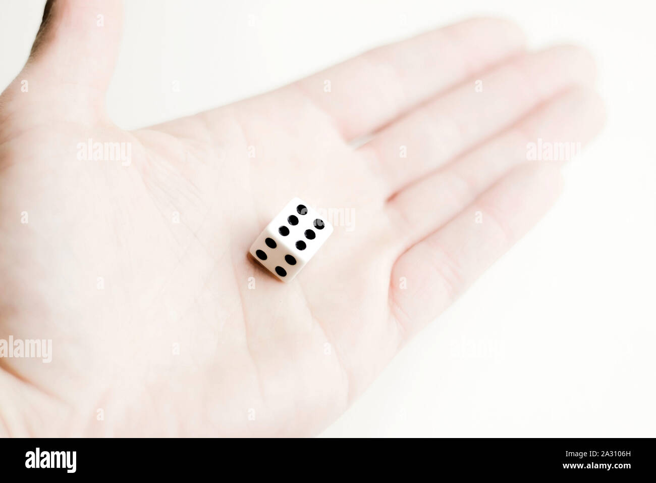 Game dice in a hand. Casino gambling. Stock Photo