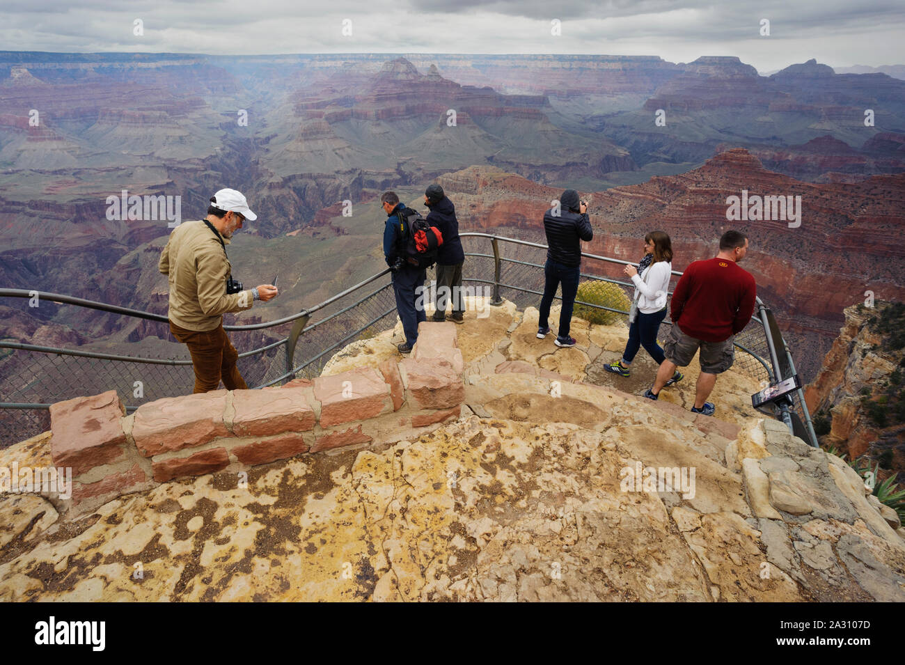 Tourists at a viewpoint on the South Rim of the Grand Canyon, Arizona, USA. Stock Photo