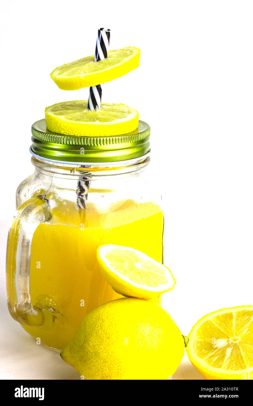 Lemonade. Lemon juice in glass jar isolated on white. Stock Photo