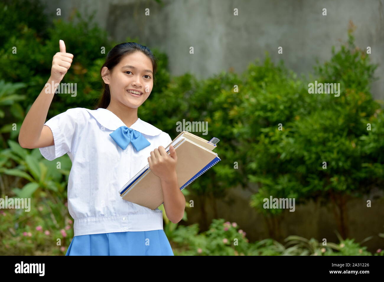 Student Teenager School Girl With Thumbs Up With School Books Stock ...