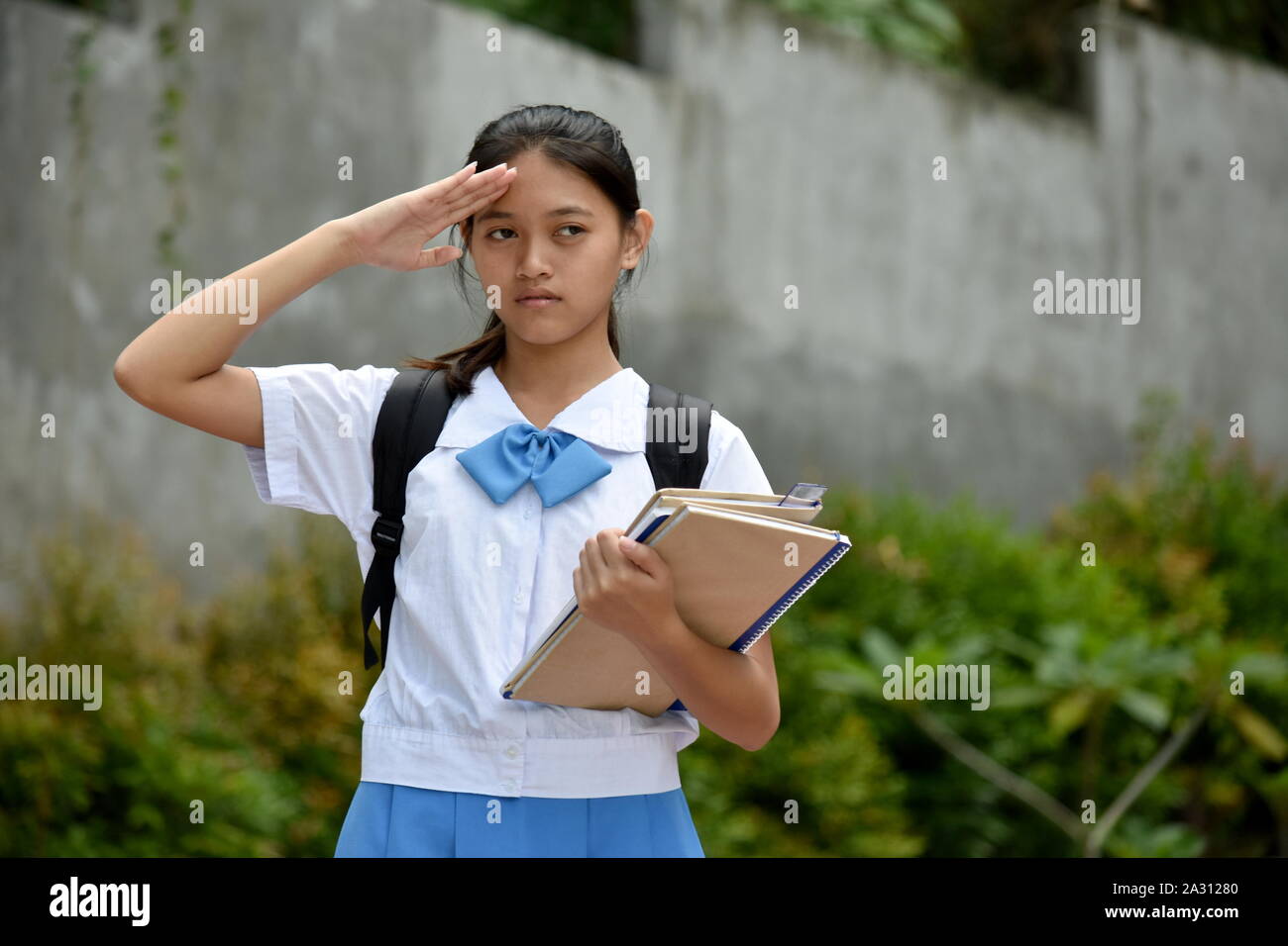 A Girl Student Saluting Stock Photo