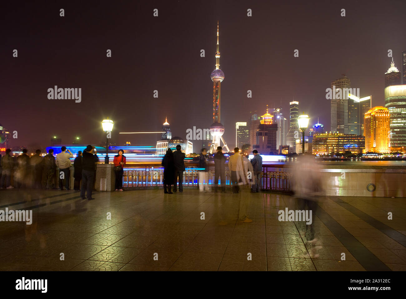 Shanhai, China - People at The Bund riverside looking at the skyline of Lujiazui and Pudong with the Oriental Pearl Tower Stock Photo