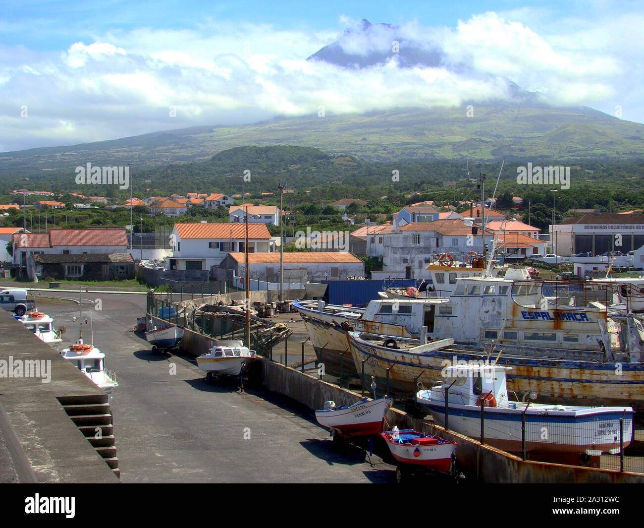 Pico volcano looming over the harbour of Madalena in the Azores ...